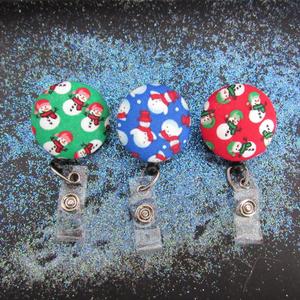 Decorative snowman badge reel in three different colors to use for your keys or ID work badge.