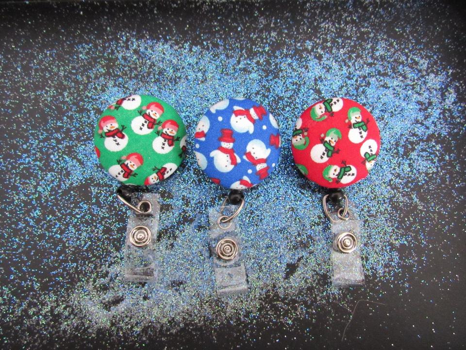 Decorative snowman badge reel in three different colors to use for your keys or ID work badge.