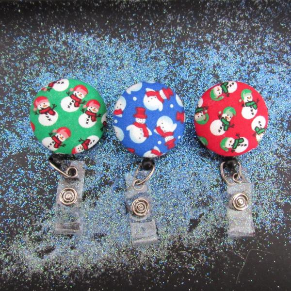 Decorative snowman badge reel in three different colors to use for your keys or ID work badge.